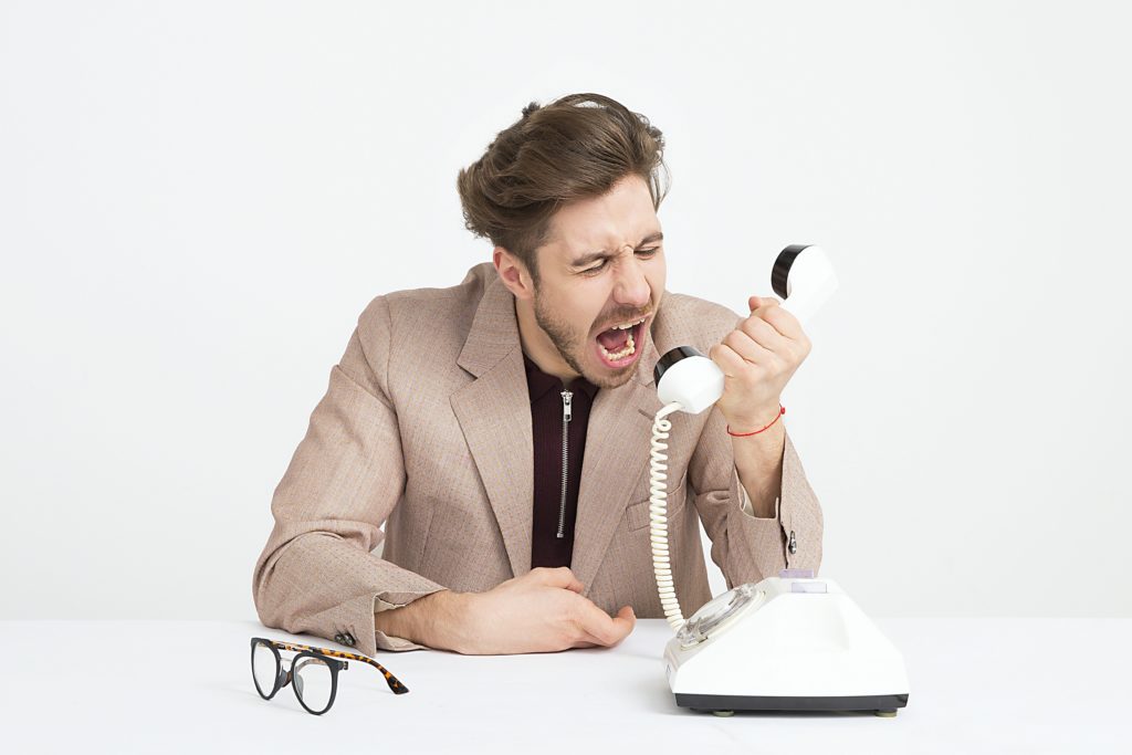 Visual of a man yelling at a phone