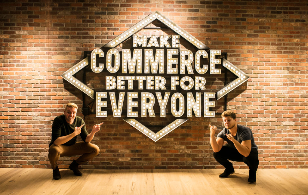 Sign reads: Make commerce better for everyone.